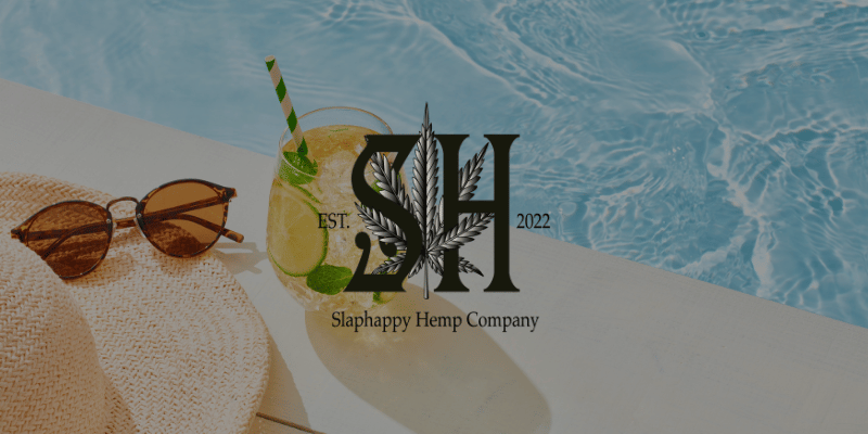 a drink, hat, and sunglasses sitting next to a pool