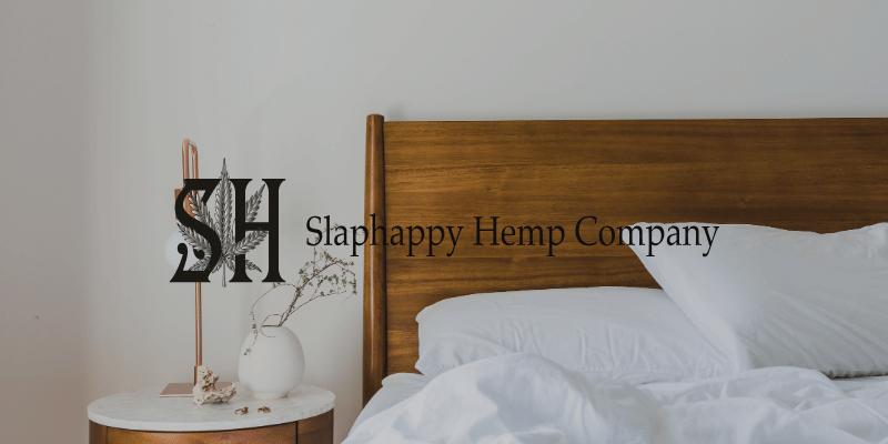 a bed and nightstand against a white wall